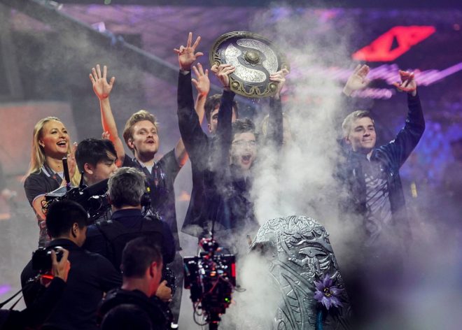 Sebastien "Ceb" Debs (C) of team OG holds the winner's trophy as the team wins the Dota 2 eSports Best of 5 final match during the International Dota 2 Championships in Shanghai on August 25, 2019. (Photo by STR / AFP) / China OUT        (Photo credit should read STR/AFP/Getty Images)