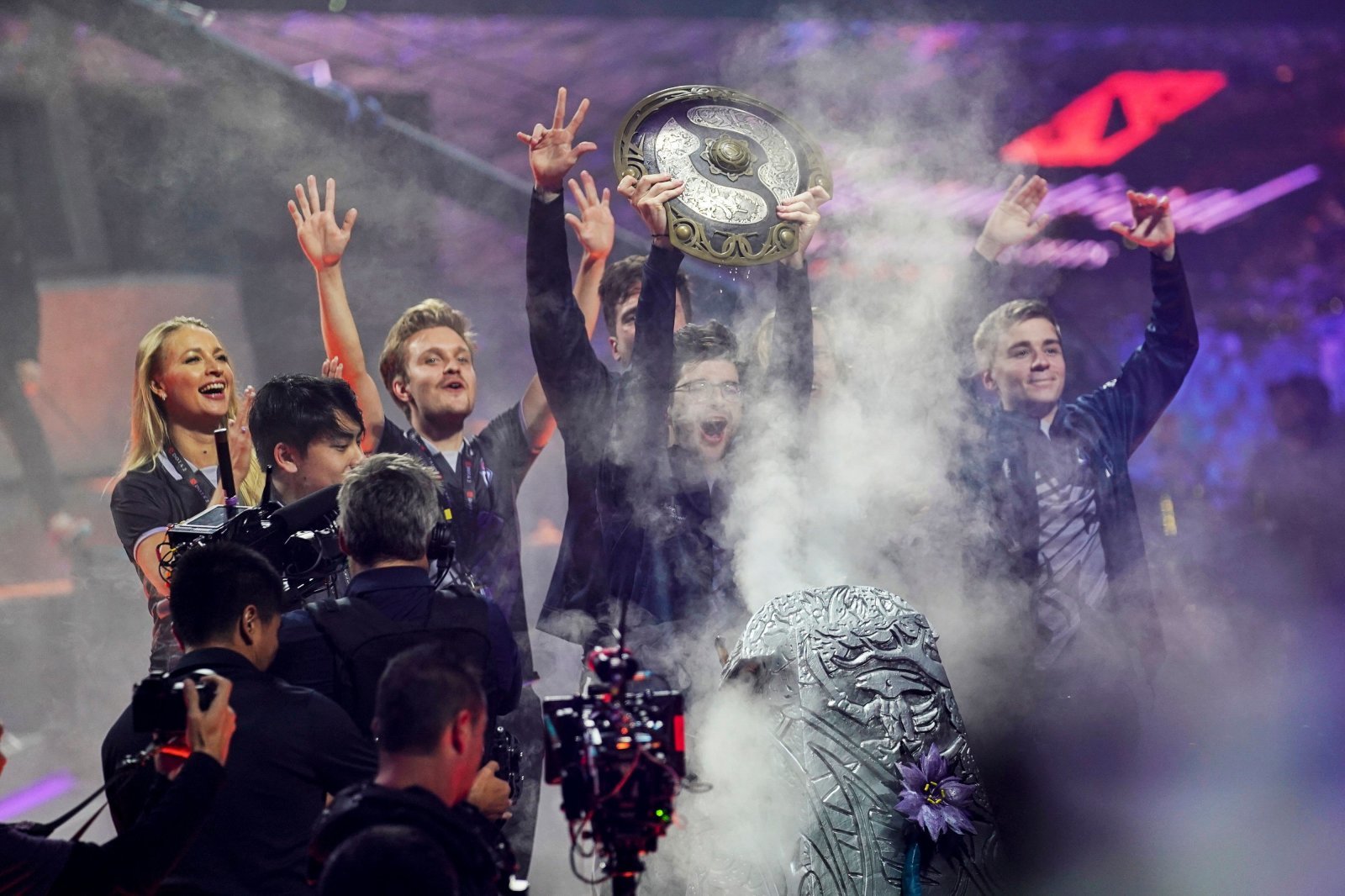 Sebastien "Ceb" Debs (C) of team OG holds the winner's trophy as the team wins the Dota 2 eSports Best of 5 final match during the International Dota 2 Championships in Shanghai on August 25, 2019. (Photo by STR / AFP) / China OUT        (Photo credit should read STR/AFP/Getty Images)