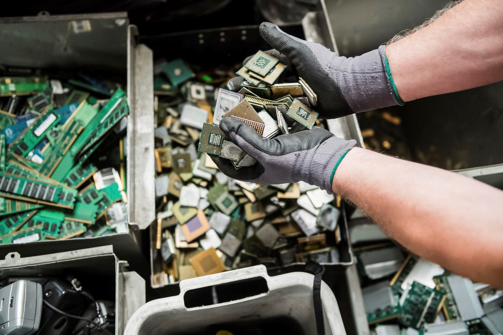 In this photo taken on July 13, 2018, a worker handles components of electronic elements at the Out Of Use company warehouse in Beringen, Belgium. Out Of Use dismantles computer, office and other equipment and recuperates an average of around 90 percent of the raw materials from electronic waste. (AP Photo/Geert Vanden Wijngaert)