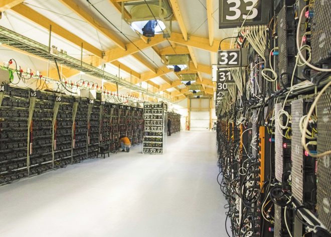 Mining rigs of a super computer are pictured inside the bitcoin factory 'Genesis Farming' near Reykjavik, on March 16, 2018. - At the heart of Iceland's breathtaking lava fields stands one of the world's largest bitcoin factories at a secret location rich in renewable energy which runs the computers creating the virtual currency. (Photo by Halldor KOLBEINS / AFP)